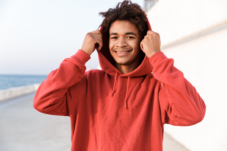 Image of a young sports african guy outdoors on the beach looking camera.の写真素材