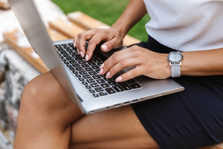 Image of a beautiful business woman using laptop computer outdoors.の写真素材