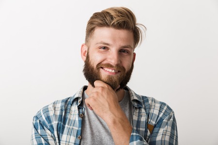 Image of a handsome young happy man standing isolated over white wall background.の写真素材