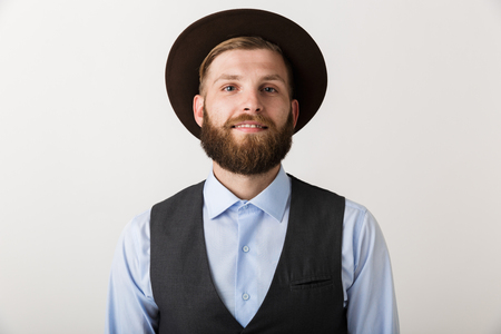 Image of a handsome young bearded man standing isolated over white wall background posing.の写真素材