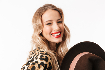 Image of a beautiful happy excited young woman with hat isolated over white wall background.の写真素材