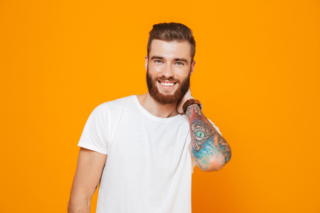 Portrait of a cheerful young man wearing casual clothes standing  looking at cameraの写真素材