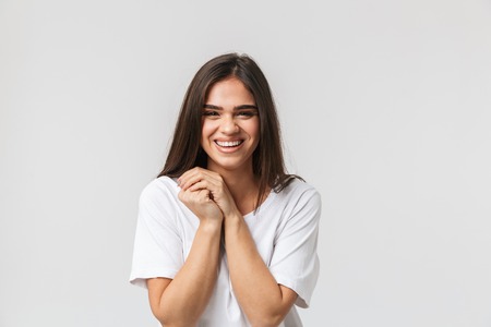 Portrait of a beautiful young woman casualy dressed standing isolated over white background