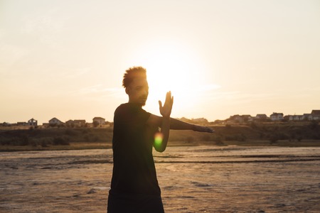 Image of a handsome young sports man make fitness exercises outdoors.の写真素材