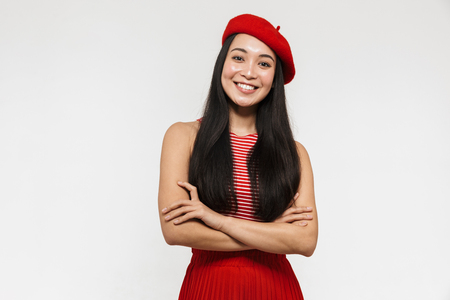 Photo of a beautiful young pretty asian happy woman posing isolated over white wall background.の写真素材