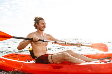 Healthy strong man kayaking on a seaの写真素材