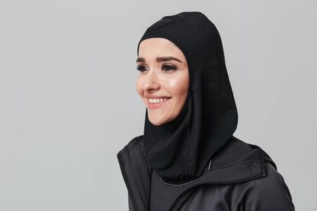 Attractive young muslim woman wearing sport hijab isolated over white background