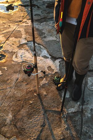 Cropped image of a handsome man fisherman at the seashore.