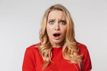 Image of shocked young pretty beautiful woman posing isolated over white wall background.の写真素材