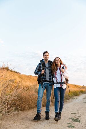 Photo of happy young loving couple outside with backpack in free alternative vacation camping.の写真素材