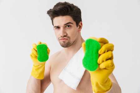 Handsome shirtless brunette houseman standing isolated over white background, holding spongesの写真素材