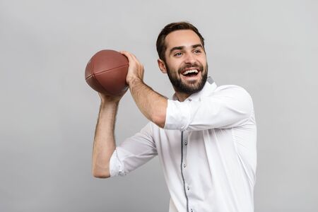 Portrait of a handsome young businessman wearing white shirt and tie standing isolated over gray...