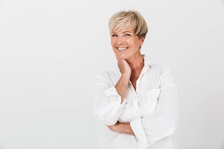 Portrait of amazed adult woman with short blond hair laughing at camera isolated over white background in studioの写真素材