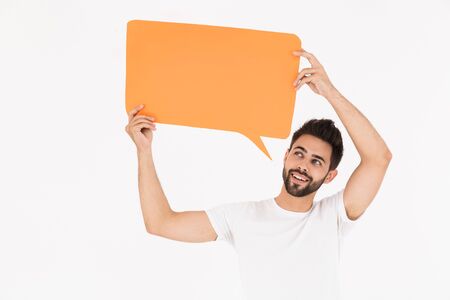Image of young smiling man holding empty placard for copyspace text isolated over white background