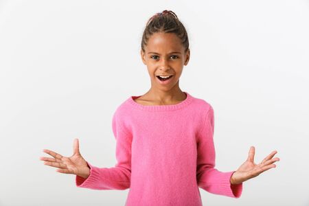 Image of african american charming girl looking at camera with throwing up hands isolated over white backgroundの写真素材