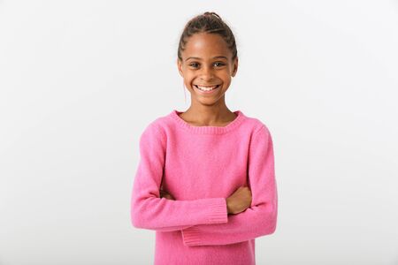 Image of african american happy girl smiling and posing with hands crossed isolated over white backgroundの写真素材