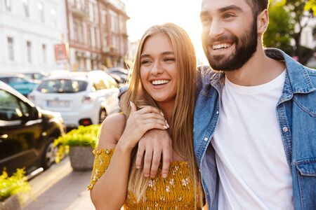 Happy lovely young couple in love spending time outdoors, hugging