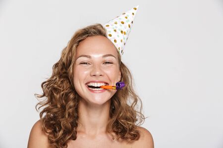 Image of happy woman with party cone and whistle laughing isolated over white backgroundの写真素材