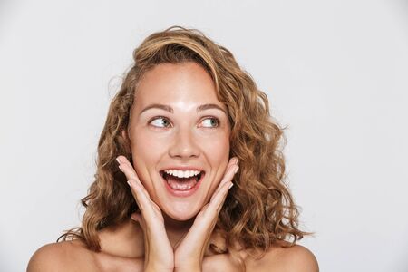 Image of happy woman laughing and looking aside isolated over white backgroundの写真素材