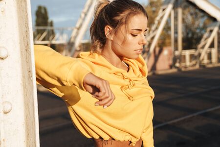 Photo of amazing concentrated pretty young fitness woman posing outdoors.の写真素材