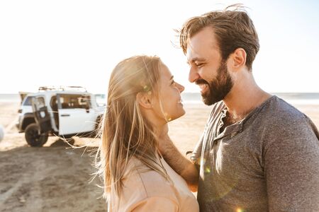 Image of happy optimistic cheerful young amazing loving couple outdoors at the beach.の写真素材