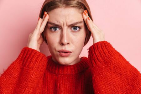 Image of shocked serious young woman posing isolated over pink wall background.の写真素材