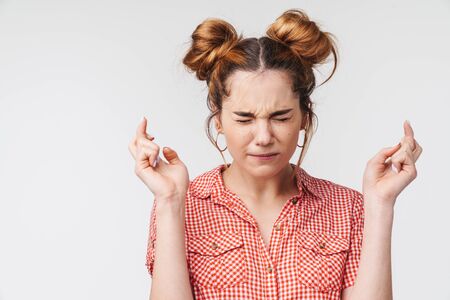 Lovely young teenage girl wearing summer clothes standing isolated over gray background, beggingの写真素材