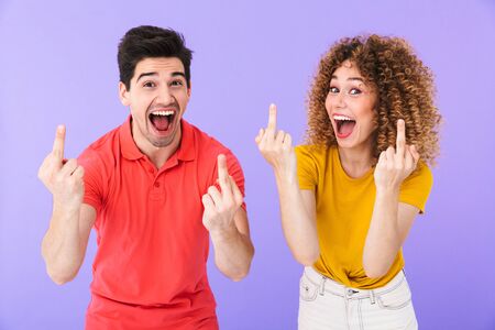 Portrait of optimistic caucasian people man and woman in basic clothing smiling and showing middle...