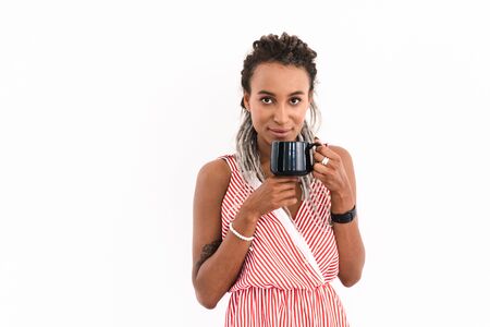 Image of a happy young cute cheery african woman with dreads posing isolated over white wall...
