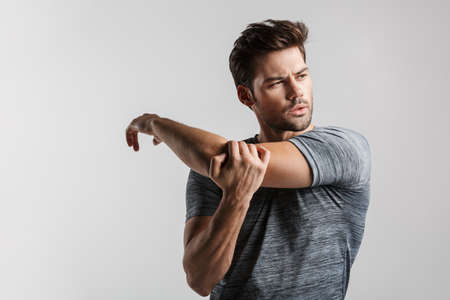 Photo of joyful half-naked man posing with towel and laughing isolated over white backgroundの写真素材