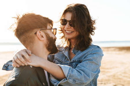 Beautiful young lovely couple spending time amazing time at the sunny beach, huggingの写真素材