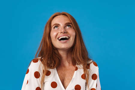 Smiling woman looking up at copy space isolatedの写真素材