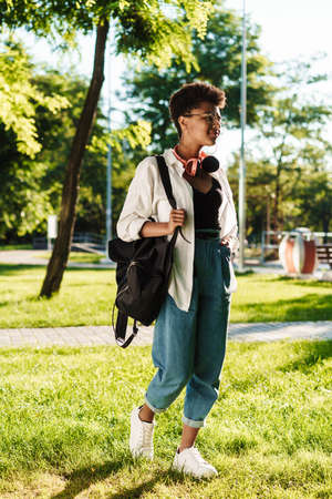 Attractive young african young student girl walking in the park