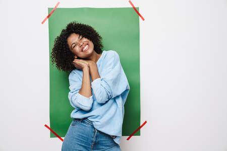 Image of excited african american woman laughing and making fun on camera isolated over multicolored...
