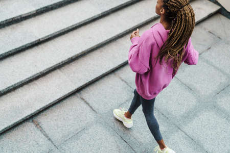 Top view of a fit young sportswoman exercising on stairs outdoors, runningの写真素材