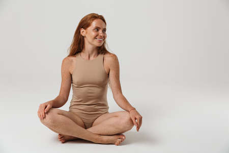 Image of happy optimistic pretty redhead woman with freckles posing isolated over white wall...