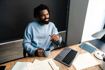 Confident young african man freelancer working at the deskの写真素材