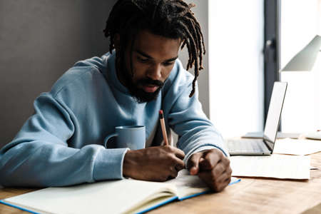 Confident young african man freelancer working at the deskの写真素材