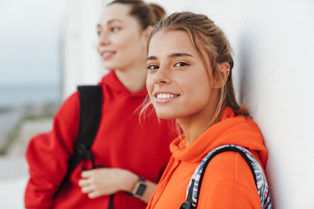 Image of a young positive optimistic beautiful girls friends walking outdoors.の写真素材