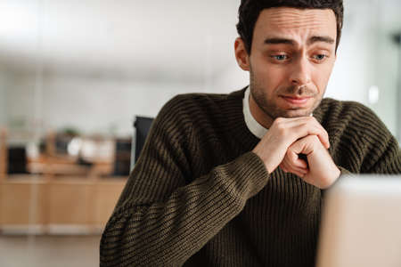 Entrepreneur working with a laptop and documents in an officeの写真素材