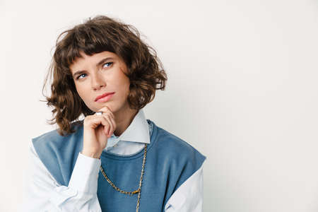 Serious beautiful girl thinking and looking aside isolated over white background