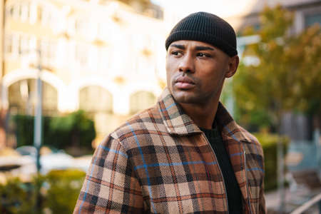 Confident stylish young afro american man walking on a street