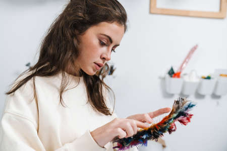 Seamstress looking at fabric samples in the workshop studioの写真素材