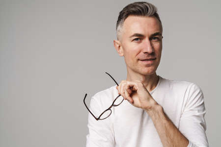 Portrait of happy smiling confident man isolated over gray background
