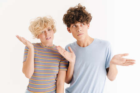 Image of confused woman with her curly brother isolated over white background