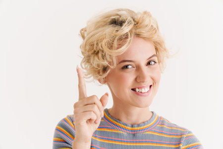 Image of happy pleased curly woman isolated over white background having an idea