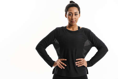 Confident african american woman posing and looking at camera isolated over white background