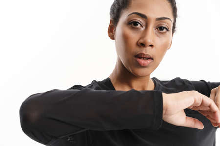 Focused african american woman doing exercise while working out isolated over white background