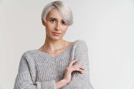 Pleased beautiful silver girl posing and looking at camera isolated over white backgroundの写真素材