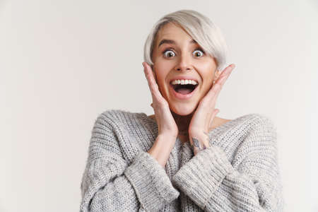 Delighted beautiful silver girl expressing surprise at camera isolated over white backgroundの写真素材